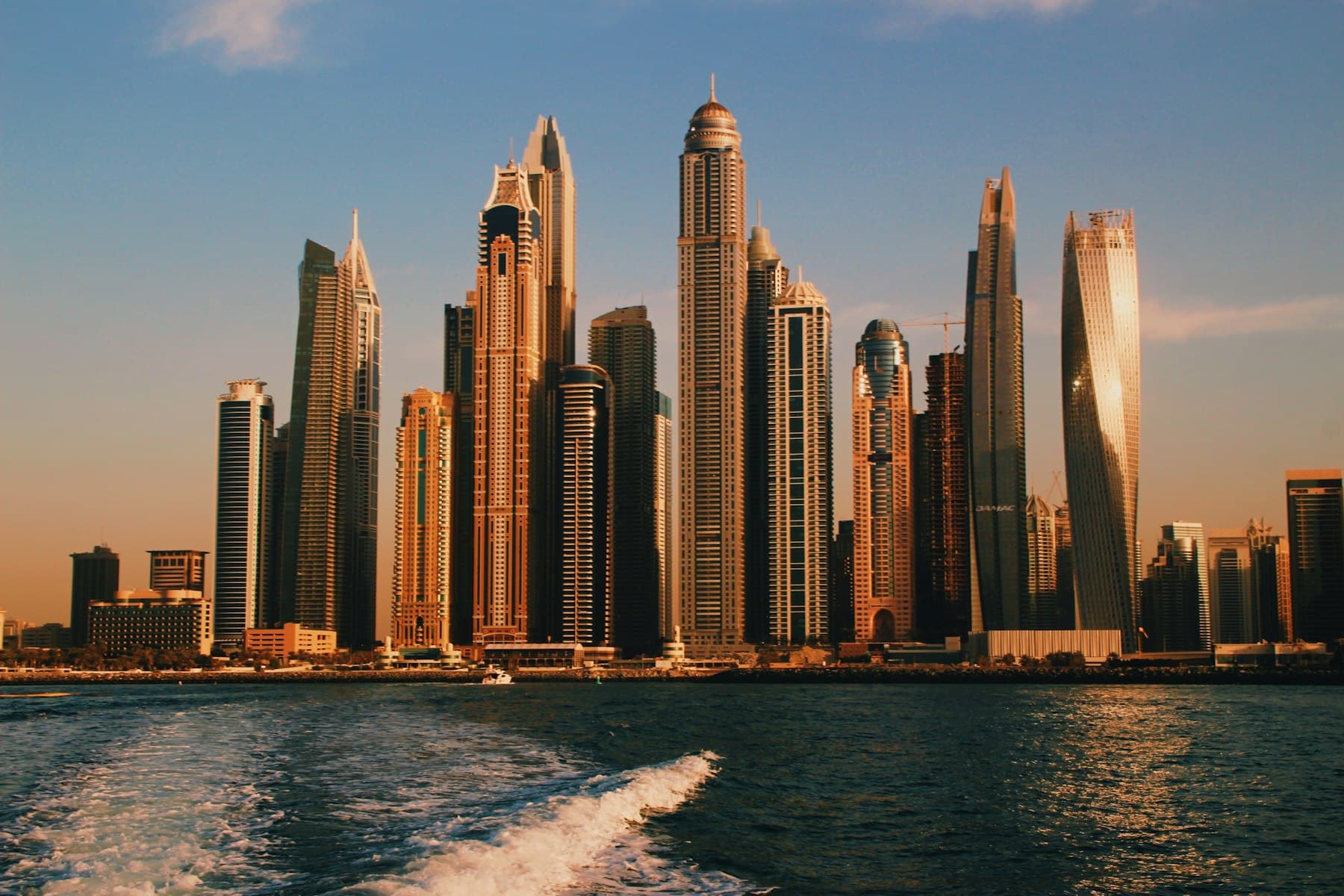 Dubai Marina skyline at sunset, seen from the water