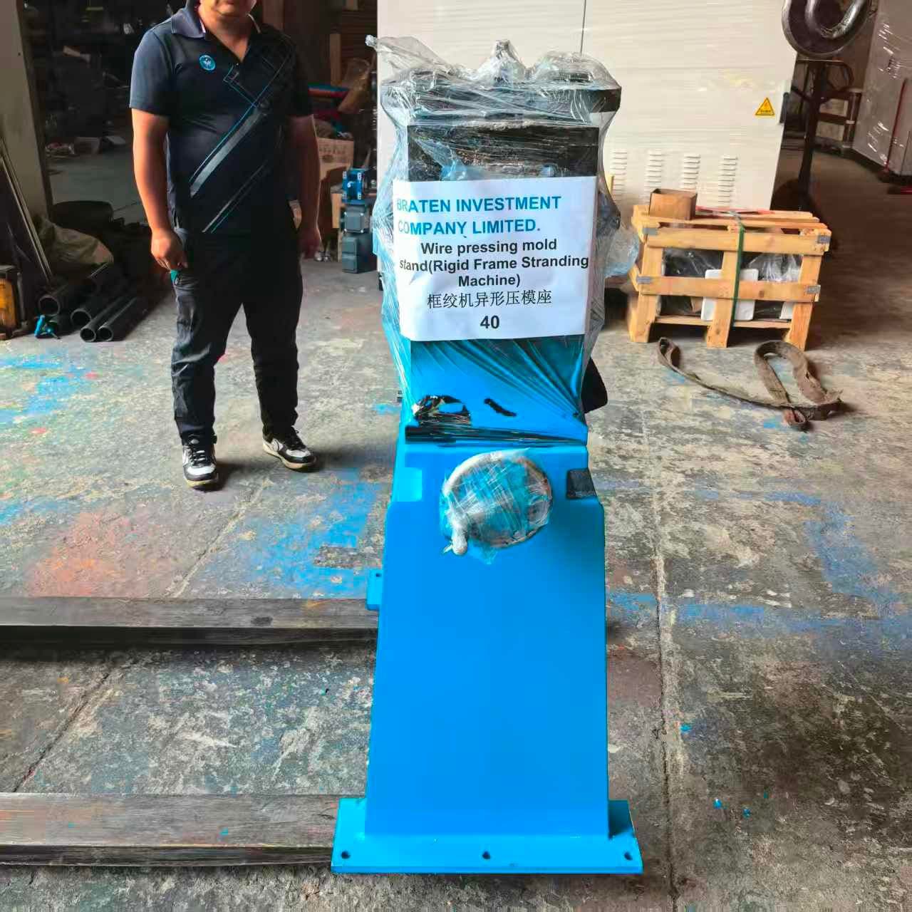 Wrapped blue machine stand labelled Braten Investment Company Limited in a workshop