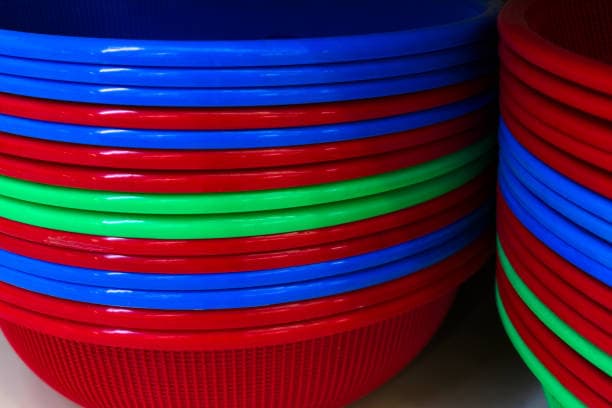 Stacked plastic basins in red, blue, and green