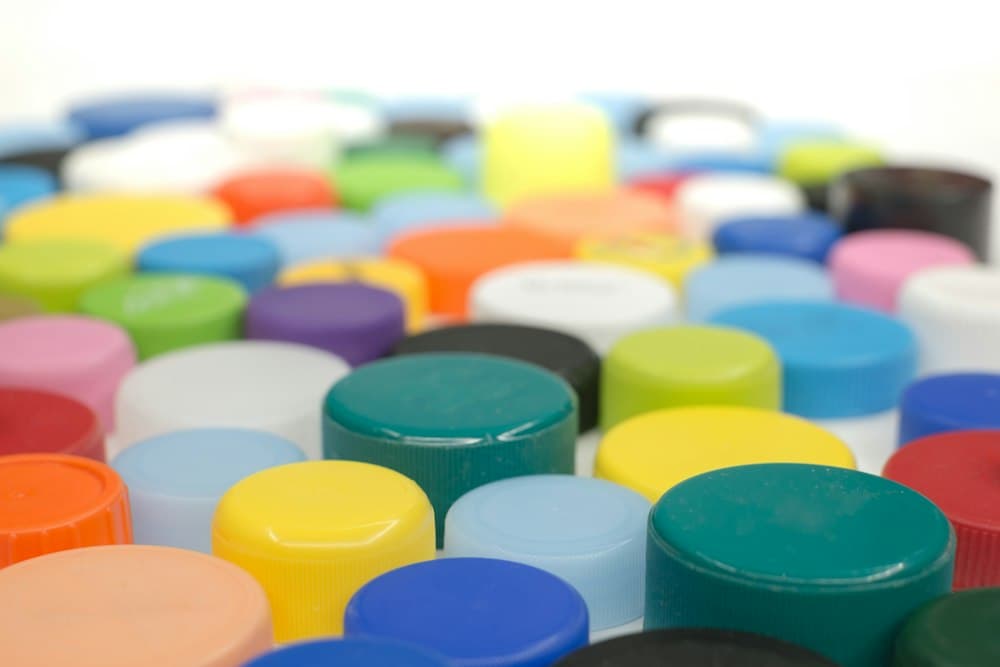 Close-up of many plastic bottle caps in different colours