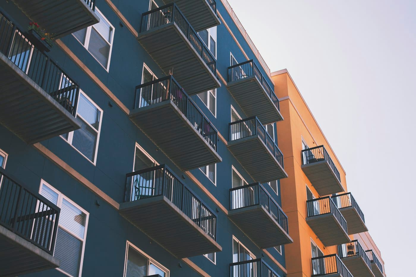 Modern apartment building with rows of private glass balconies